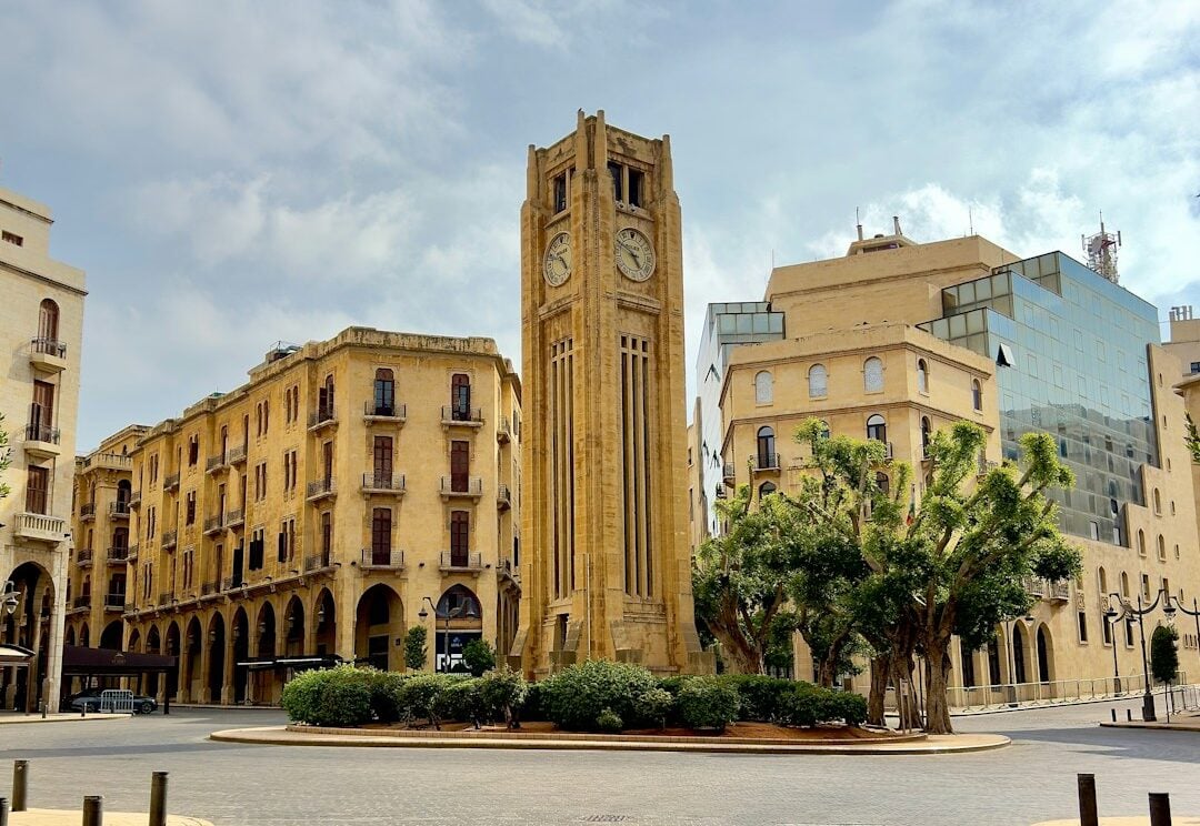 a large clock tower sitting in the middle of a courtyard