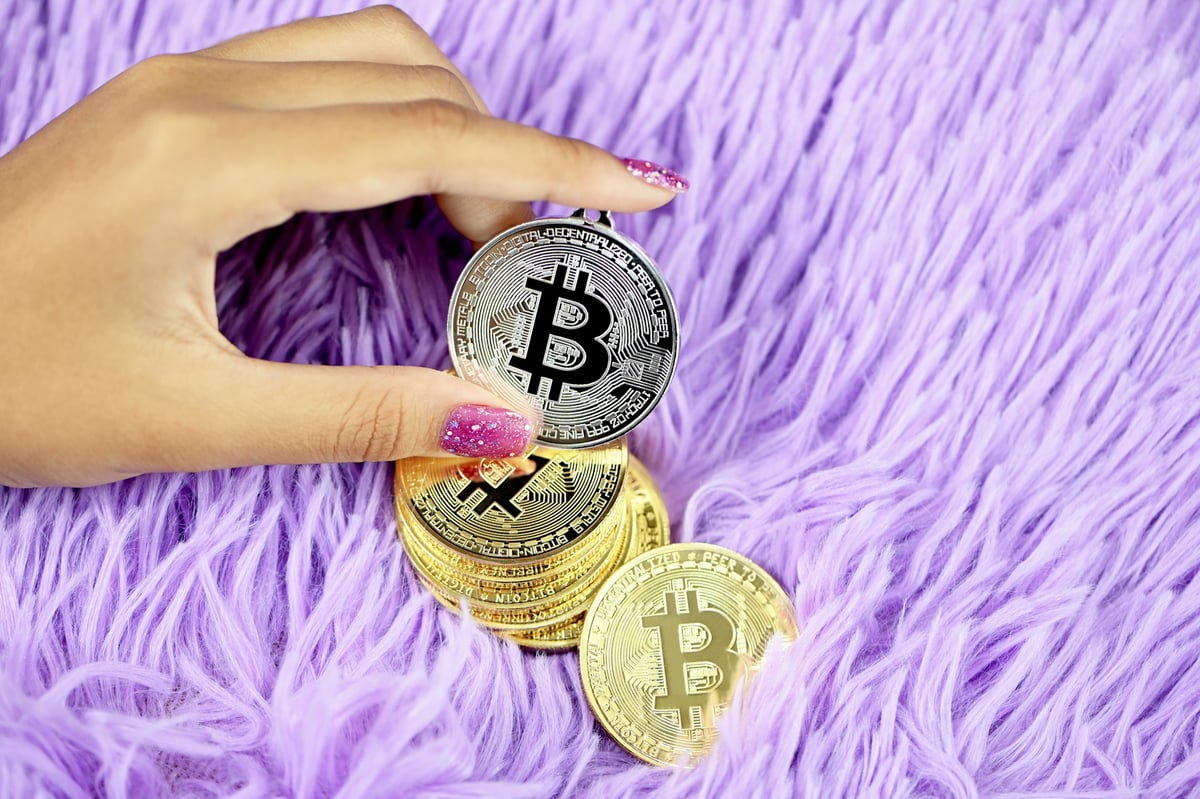 person holding gold and silver coins