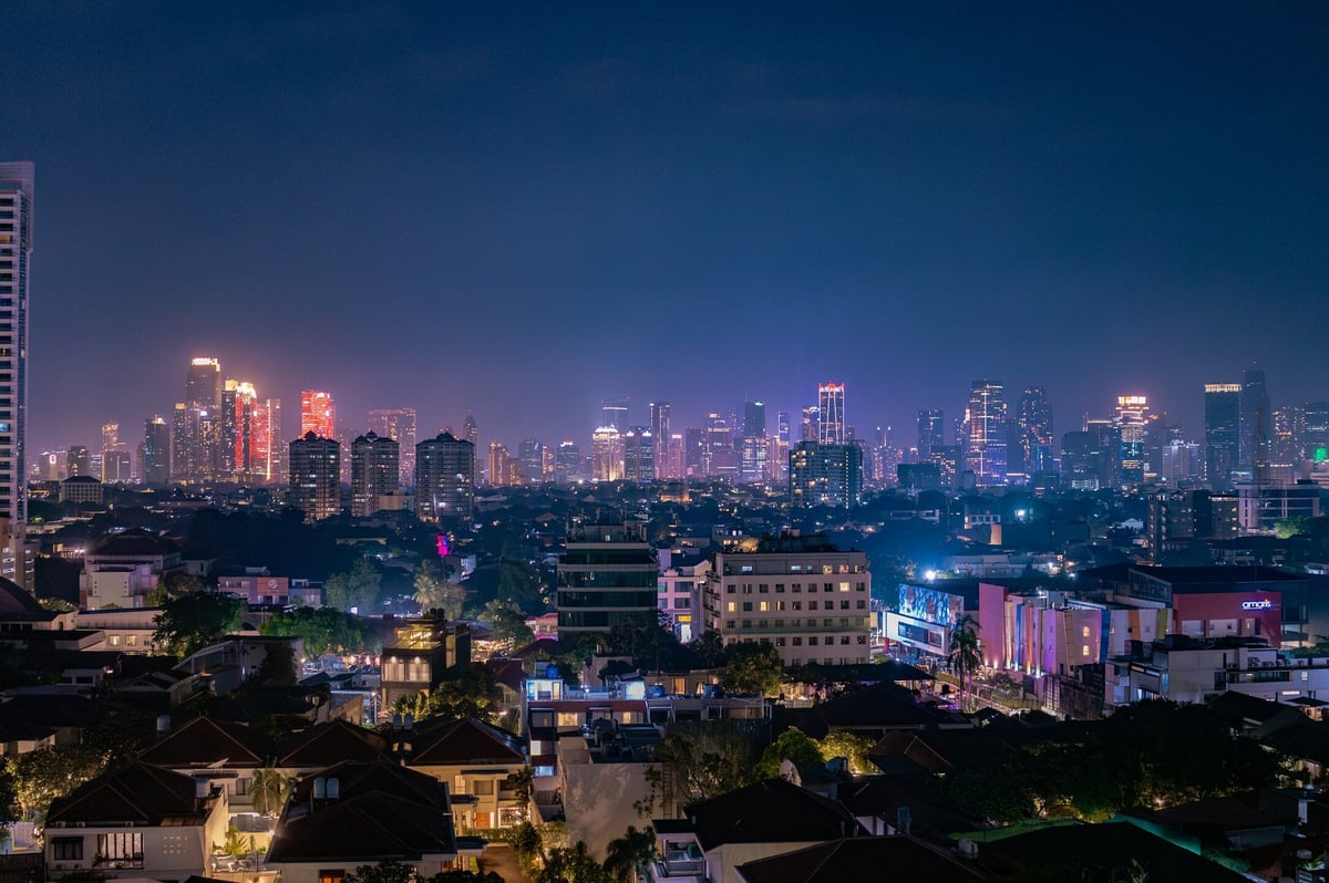 A view of a city at night from the top of a building