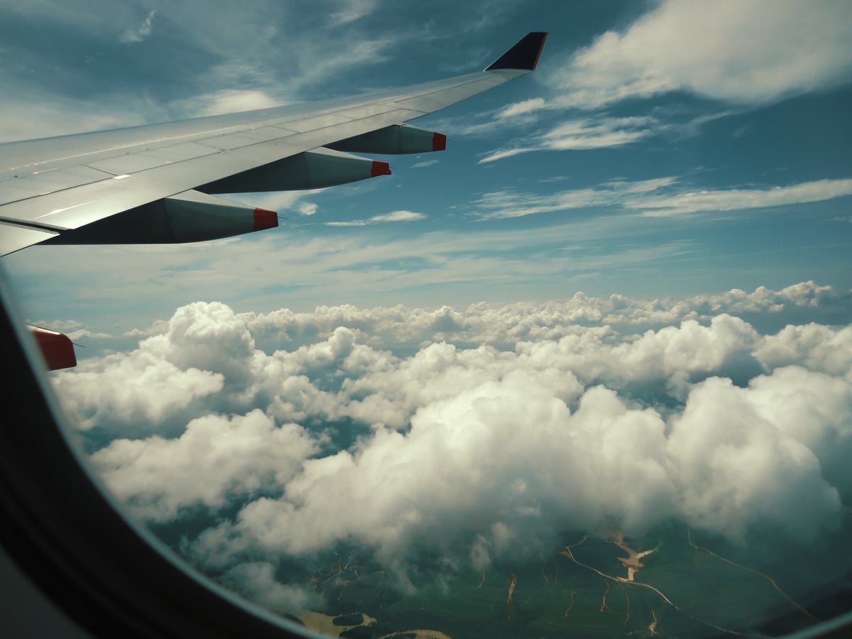 Serene view of fluffy white clouds from an airplane window during a scenic flight.