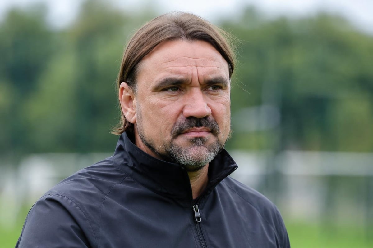 A photorealistic, cinematic close-up portrait of [Daniel Farke], capturing their distinct, highly recognizable celebrity facial features and exact bone structure perfectly. Shot in a 16:9 aspect ratio. The face has a focused, determined expression. They are styled in a random, plain, unbranded athle