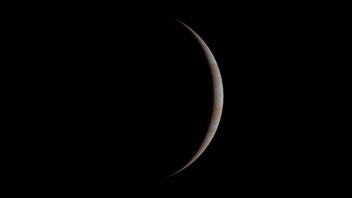 Captivating crescent view of Jupiter with distinct atmospheric bands against the black void of space.