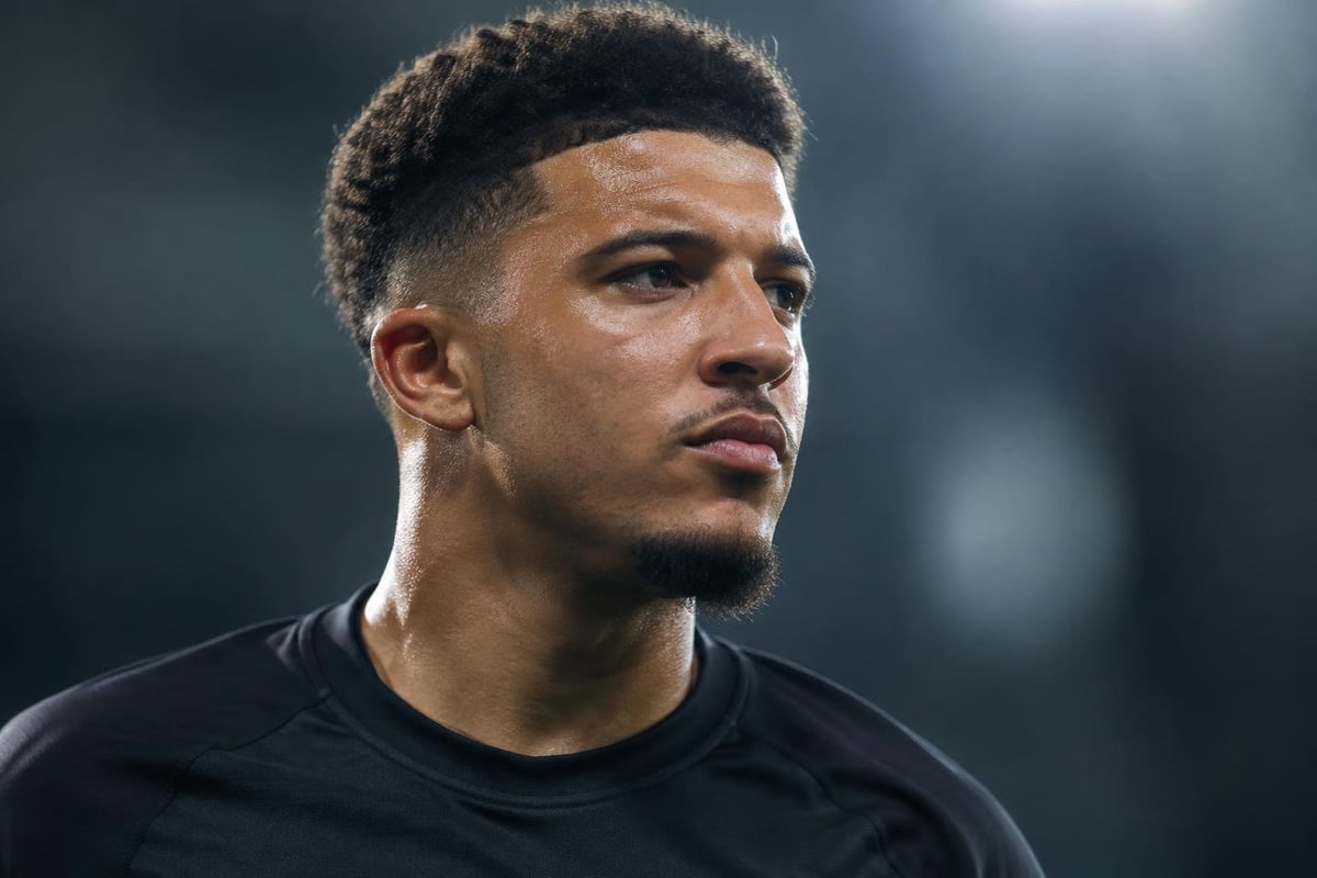 A photorealistic, cinematic close-up portrait of [Jadon Sancho], capturing their distinct, highly recognizable celebrity facial features, exact bone structure, specific jawline, and natural eye shape perfectly. Shot in a 16:9 aspect ratio. The face has a determined, focused expression with subtle sw