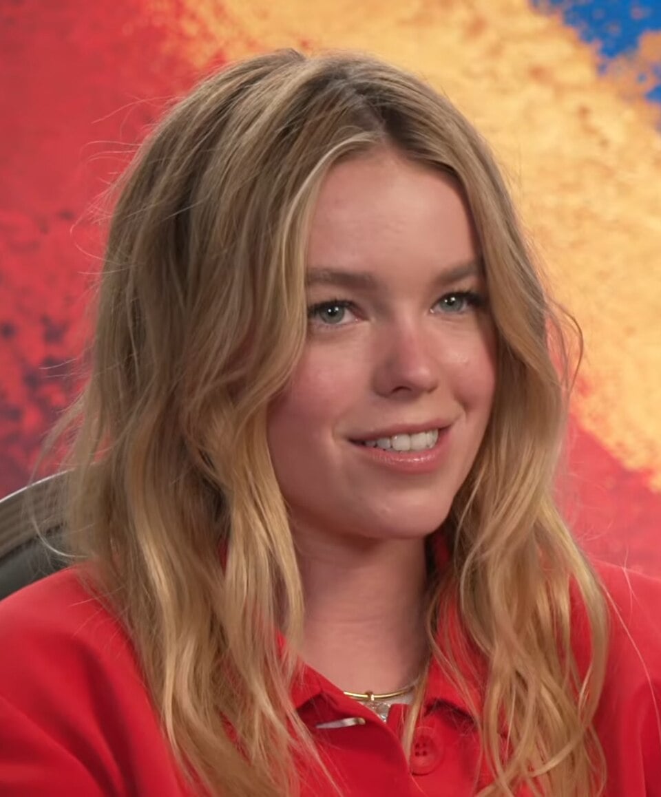 Milly Alcock during an interview with Margaret Gardiner promoting the film Supergirl in June 2026